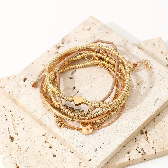 Sjika - Gold plated armbanden set – 7-delige damesarmbanden met kralen, bedels & hartdetail – Boho chic & elegant design – Perfect cadeau voor haar