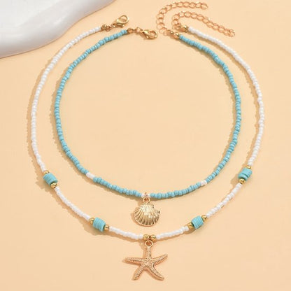 Sjika - Bohemian Strand Ketting Dames – 2 Delige Kralen Ketting Set met Zeester & Schelp Hanger – Zomer Choker Kettingen Wit Blauw Goud - Cadeau voor haar