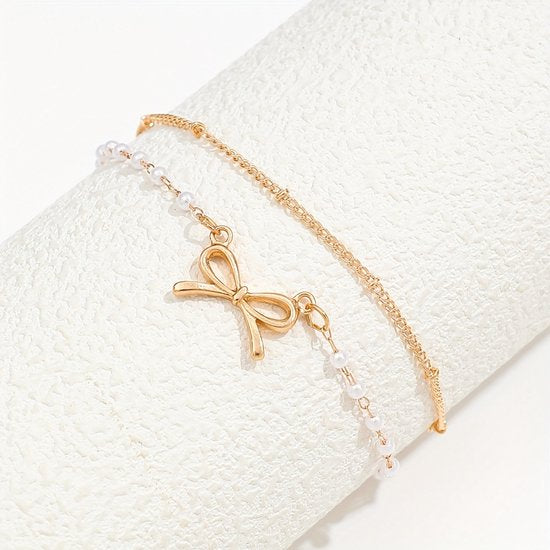 Sjika - Enkelbandje Dames Goudkleurig met Strik & Parels – Dubbele Enkelband – Trendy Zomer Enkelketting – Boho Voetsieraad - Cadeau voor haar