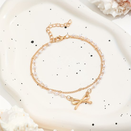 Sjika - Enkelbandje Dames Goudkleurig met Strik & Parels – Dubbele Enkelband – Trendy Zomer Enkelketting – Boho Voetsieraad - Cadeau voor haar