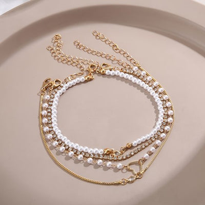 Sjika - Gouden Armbandenset Dames – 4 Delige Set met Parels, Hartje & Zirkonia – Luxe Layered Armbanden – Verstelbaar - Cadeau voor haar