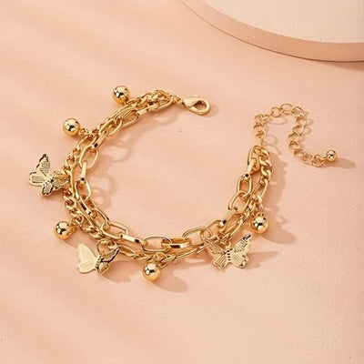 Sjika - Gouden Vlinder Armband Dames – Schakelarmband met Bedels – Verstelbare Armband – Trendy Sieraad – Gold Plated
