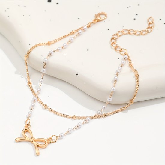 Sjika - Enkelbandje Dames Goudkleurig met Strik & Parels – Dubbele Enkelband – Trendy Zomer Enkelketting – Boho Voetsieraad - Cadeau voor haar