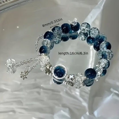 Sjika - Blauwe Galaxy Armband Dames – Luxe Glas & Crackle Kralen – Ster Bedels – Elegant Cadeau Sieraad – Verstelbare Armband - Cadeau voor haar