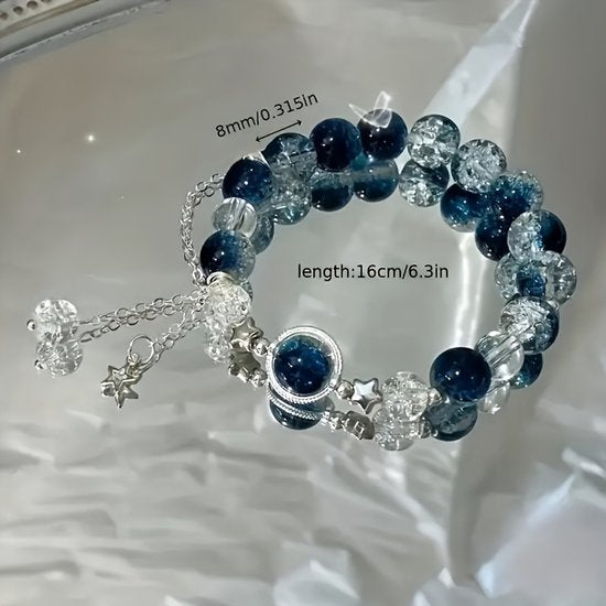 Sjika - Blauwe Galaxy Armband Dames – Luxe Glas & Crackle Kralen – Ster Bedels – Elegant Cadeau Sieraad – Verstelbare Armband - Cadeau voor haar