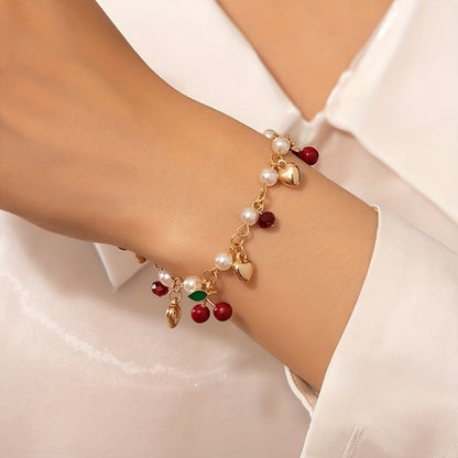 Sjika - Gold plated armband met parels, hartjes & kersbedels – Trendy damesarmband – Speels & elegant design – Perfect cadeau voor haar